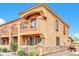 Two-story stucco home with a balcony and stone accents at 21655 N 36Th Ave # 104, Glendale, AZ 85308