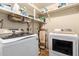 Laundry room with washer, dryer, and storage shelves at 1360 W 15Th St, Tempe, AZ 85281