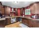 Kitchen with dark wood cabinets and granite countertops at 1360 W 15Th St, Tempe, AZ 85281