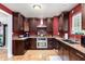 Kitchen with dark wood cabinets and granite countertops at 1360 W 15Th St, Tempe, AZ 85281