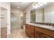 Bathroom boasts dual sinks, granite countertops, and a walk-in shower at 120 E Camellia Way, San Tan Valley, AZ 85140