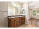 Double vanity bathroom with granite countertops and view into bedroom at 120 E Camellia Way, San Tan Valley, AZ 85140