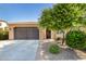 Tan house with brown garage door, landscaping, and a paved driveway at 120 E Camellia Way, San Tan Valley, AZ 85140