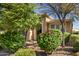 Landscaped front yard with lush green bushes and trees at 120 E Camellia Way, San Tan Valley, AZ 85140