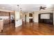 Open kitchen with island, stainless steel appliances, and hardwood floors at 120 E Camellia Way, San Tan Valley, AZ 85140