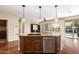 Island kitchen with granite countertops and stainless steel appliances at 120 E Camellia Way, San Tan Valley, AZ 85140