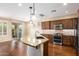Kitchen with granite island, stainless steel appliances, and hardwood floors at 120 E Camellia Way, San Tan Valley, AZ 85140