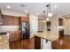 Open kitchen features granite island, stainless steel appliances, and hardwood floors at 120 E Camellia Way, San Tan Valley, AZ 85140