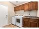 Laundry room with washer, dryer, and built-in cabinets at 120 E Camellia Way, San Tan Valley, AZ 85140