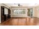 Spacious living room with hardwood floors and built-in entertainment center at 120 E Camellia Way, San Tan Valley, AZ 85140