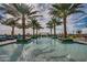 Resort-style pool with palm trees and lounge chairs at 120 E Camellia Way, San Tan Valley, AZ 85140
