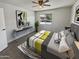 Bright bedroom with grey carpet, ceiling fan, and modern decor at 3511 E Baseline Rd # 1031, Phoenix, AZ 85042