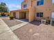 Tan stucco condo with double doors and walkway at 3511 E Baseline Rd # 1031, Phoenix, AZ 85042