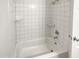 Clean bathroom with white tile and shower/tub combo at 3511 E Baseline Rd # 1031, Phoenix, AZ 85042