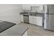Modern kitchen with white cabinets, grey countertops, and stainless steel appliances at 3511 E Baseline Rd # 1031, Phoenix, AZ 85042