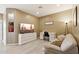 Home office with a desk, couch, and large TV at 1438 W Coral Reef Dr, Gilbert, AZ 85233