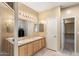 Double vanity bathroom with a shower and access to closet at 1438 W Coral Reef Dr, Gilbert, AZ 85233