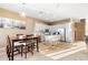 Modern kitchen with white cabinets, a kitchen island, and a dining area at 1438 W Coral Reef Dr, Gilbert, AZ 85233