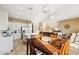 Bright kitchen with white cabinets, an island, and a dining area at 1438 W Coral Reef Dr, Gilbert, AZ 85233