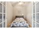 Small bedroom with a floral bedspread and French doors at 1438 W Coral Reef Dr, Gilbert, AZ 85233