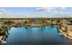 Aerial view of lakefront community featuring a central fountain and mature trees at 1438 W Coral Reef Dr, Gilbert, AZ 85233