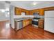 Kitchen with wood cabinets, granite countertops, and stainless steel appliances at 1750 E Mateo Cir # 103, Mesa, AZ 85204