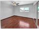 Well-lit bedroom with wood floors and mirrored closet doors at 1750 E Mateo Cir # 103, Mesa, AZ 85204