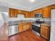 Kitchen with wood cabinets, granite countertops, and stainless steel appliances at 1750 E Mateo Cir # 103, Mesa, AZ 85204