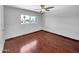 Bright bedroom with wood flooring and a window offering an exterior view at 1750 E Mateo Cir # 103, Mesa, AZ 85204