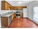 Kitchen with wood floors, granite counters, and stainless steel appliances at 1750 E Mateo Cir # 103, Mesa, AZ 85204