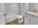 Bathroom with granite vanity, white fixtures, and a bathtub at 1750 E Mateo Cir # 103, Mesa, AZ 85204