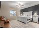 Spacious primary bedroom with a king-size bed and ceiling fan at 11225 E Ocaso Ave, Mesa, AZ 85212