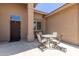 Small patio with table and chairs near the front door at 11225 E Ocaso Ave, Mesa, AZ 85212