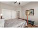 Bright bedroom with double door closet and wood post bed frame at 11225 E Ocaso Ave, Mesa, AZ 85212