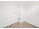 Simple laundry room with wood-look flooring at 632 N 72Nd Pl, Scottsdale, AZ 85257