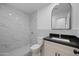 Updated bathroom features a walk-in shower, marble tile, and modern vanity at 632 N 72Nd Pl, Scottsdale, AZ 85257