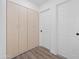 Hallway with built-in storage and light wood laminate floors at 632 N 72Nd Pl, Scottsdale, AZ 85257