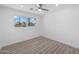 Bright bedroom featuring wood-look flooring and a large window at 632 N 72Nd Pl, Scottsdale, AZ 85257
