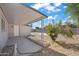 Covered patio, spacious backyard with gravel and small tree at 632 N 72Nd Pl, Scottsdale, AZ 85257