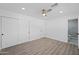 Bright bedroom with hardwood floors, double doors, and ceiling fan at 632 N 72Nd Pl, Scottsdale, AZ 85257