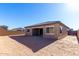 View of the backyard featuring a covered patio, dirt landscape, and a block wall at 16348 W Avenida Del Sol --, Surprise, AZ 85387