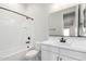 White bathroom with black fixtures, white tiled shower and tub, and single vanity at 16348 W Avenida Del Sol --, Surprise, AZ 85387