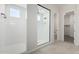 Bright bathroom with a walk-in shower, white tile, and a glass enclosure at 16348 W Avenida Del Sol --, Surprise, AZ 85387