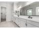 Modern bathroom with double vanity, white cabinets, and black fixtures at 16348 W Avenida Del Sol --, Surprise, AZ 85387