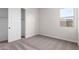 Empty bedroom with carpet flooring and an open closet door at 16348 W Avenida Del Sol --, Surprise, AZ 85387
