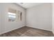 Empty bedroom with wood-look laminate floors and two windows at 16348 W Avenida Del Sol --, Surprise, AZ 85387