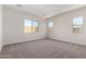 Spacious, unfurnished bedroom with neutral carpeting and multiple windows at 16348 W Avenida Del Sol --, Surprise, AZ 85387
