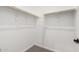 Empty walk-in closet with white walls, carpet, and built-in wooden shelving at 16348 W Avenida Del Sol --, Surprise, AZ 85387