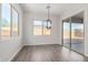 Dining area with modern chandelier and sliding glass door leading to the backyard at 16348 W Avenida Del Sol --, Surprise, AZ 85387