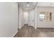 Home entryway with wood-look flooring, white walls, and access to main living area at 16348 W Avenida Del Sol --, Surprise, AZ 85387